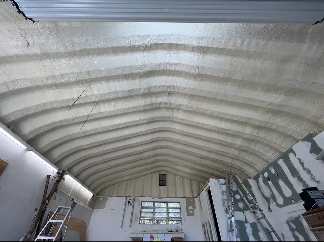 Spray polyurethane foam applied to the underside of a metal roof deck in Georges